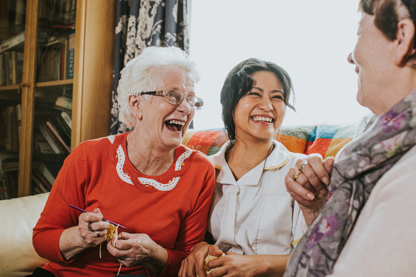 Care assistant visits elderly woman